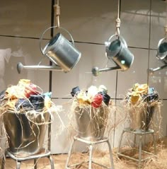 pots and pans are hanging on the wall in front of a display case with straw