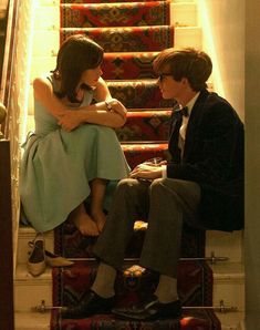 a man and woman sitting on top of a stair case with the caption in arabic