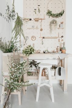 a white room with plants and decorations on the wall