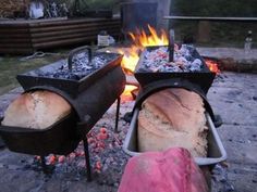 two breads being cooked over an open fire pit