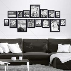 a black and white living room with pictures on the wall, coffee table and couch