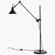 a black floor lamp on a white background with a cord attached to the light fixture