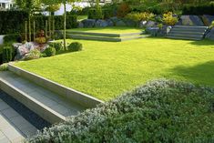 an outdoor area with steps, grass and bushes