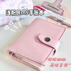 a pink wallet sitting on top of a table