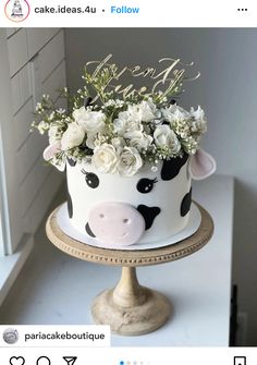 a cake decorated with flowers and a cow face