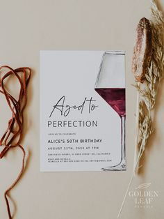 a wine glass and some dried grass on a table