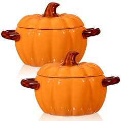 two orange pumpkin shaped dishes sitting next to each other