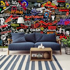 a couch sitting in front of a wall covered with graffiti