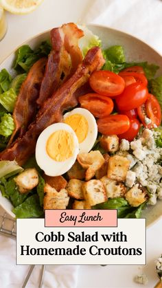 cobb salad with homemade croutons and bacon on the side in a white bowl