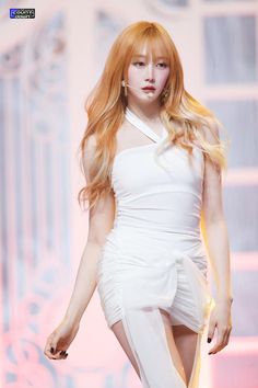 a woman with long red hair wearing a white dress