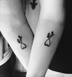 two people with matching tattoos on their arms