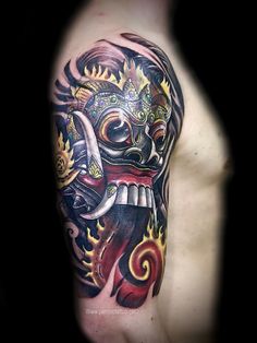 a man's half sleeve tattoo with a demon and flames on his arm,