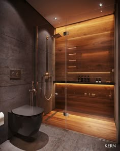 a modern bathroom with wooden walls and flooring, along with a glass enclosed shower stall