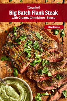 steak with creamy chimichrii sauce on a cutting board next to a bowl of guacamole