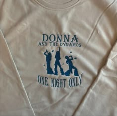 ⭐️We have a 2-5 week processing time on all of our clothing orders ⭐️ This design is inspired by the Mamma Mia film series, as part of our musical collection. This design features the iconic donna and the dynamos group from the movies. This design is embroidered on a cream sweatshirt with indigo thread, and a Natural Tote with Indigo Thread . All our sweatshirts are a 50% cotton/ 50% polyester blend, and are slightly oversized/unisex! This Tote is 38x42cm and made from 100% cotton/ethically made Dynamos Mamma Mia, Donna And The Dynamos, The Dynamos, Cream Sweatshirt, The Clique, Mia 3, Embroidered Sweatshirt