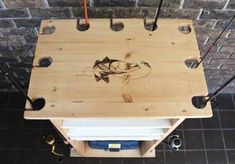 a wooden box with some wires attached to it and a fish drawing on the side