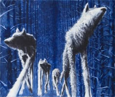 three wolfs are standing in the snow together