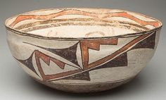 a white bowl with brown and orange designs on it