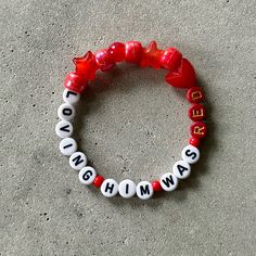 two red and white bracelets with words on them