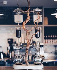 a tree made out of glass bottles on top of a counter