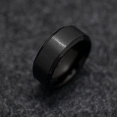 a black ring sitting on top of a gray carpet