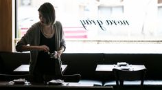 a woman standing in front of a window