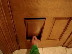 a person is reaching into a door with their foot on the floor in front of them