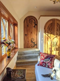 a living room filled with furniture and lots of wood trimming on the walls next to windows