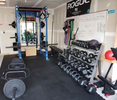 there is a gym with many different types of equipment in the room and on the wall