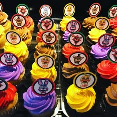 many cupcakes are decorated with colorful frosting