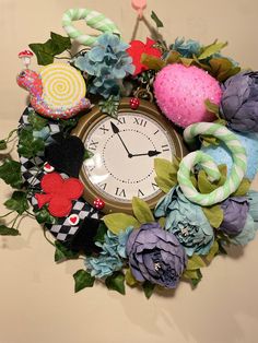 a clock decorated with fabric flowers and other things on the wall behind it is an ornament