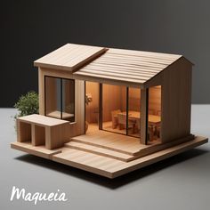 a small wooden house sitting on top of a table