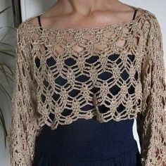 a woman is wearing a crocheted top with long sleeves and an open back