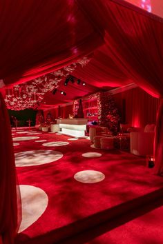 a red carpet with white polka dots on it in a room that is lit up