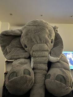 an elephant stuffed animal sitting on top of a desk