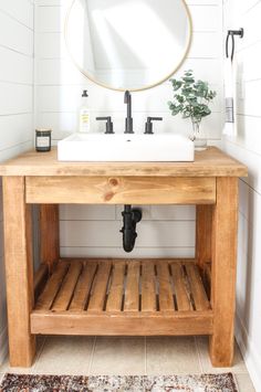 a bathroom with a sink, mirror and wooden bench in it's corner area