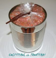 an open tin can filled with food on top of a table