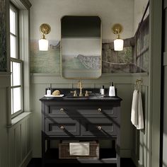 a bathroom with two sinks and a large mirror on the wall above it's counter