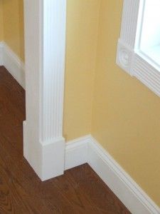 an empty hallway with yellow walls and wood flooring in the corner is seen from above