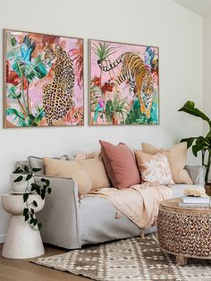 a living room with two paintings on the wall