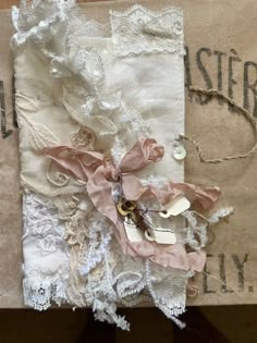 an altered piece of fabric with lace and buttons