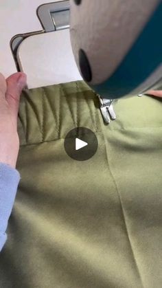 someone is using a sewing machine to sew something on the side of a shirt