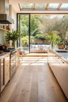 an open kitchen with wooden floors and white cabinets is shown in this modern style home