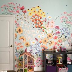 a child's room with flowers painted on the wall