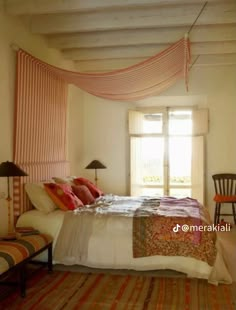 a bed sitting under a window in a bedroom