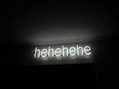 a neon sign that reads heinehere in the dark