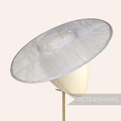 *This is not a fitted hat! You will need to attach a headband, comb or elastic to secure it to your head* This cartwheel hat base is a classic shape that has sprung into popularity in the past year. Made from 2 layers of stiffened sinamay, these cartwheels are ready to trim and are fitted with a petersham ribbon on the inside crown edge. Simply add a comb or headband to secure to the head. Hat base measures: Width: 35.5cm (14 inches) Crown Width: 13.5cm (5.3 inches) Crown Height: Approximately 3 Cartwheel Hat, Sinamay Fabric, Sinamay Fascinator, Blank Hats, Millinery Supplies, Hat Base, Crown Heights, Velvet Flowers, Feather Flower