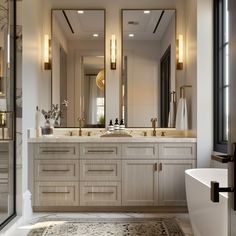 a large bathroom with two sinks, mirrors and a bathtub in the middle of it