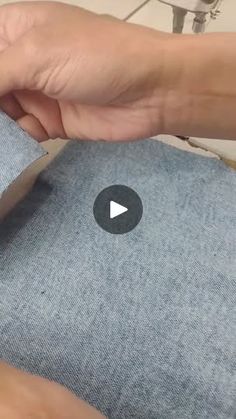 someone cutting fabric with a pair of scissors