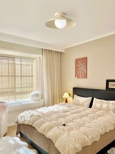 a bedroom with a large bed and two lamps on either side of the window sill